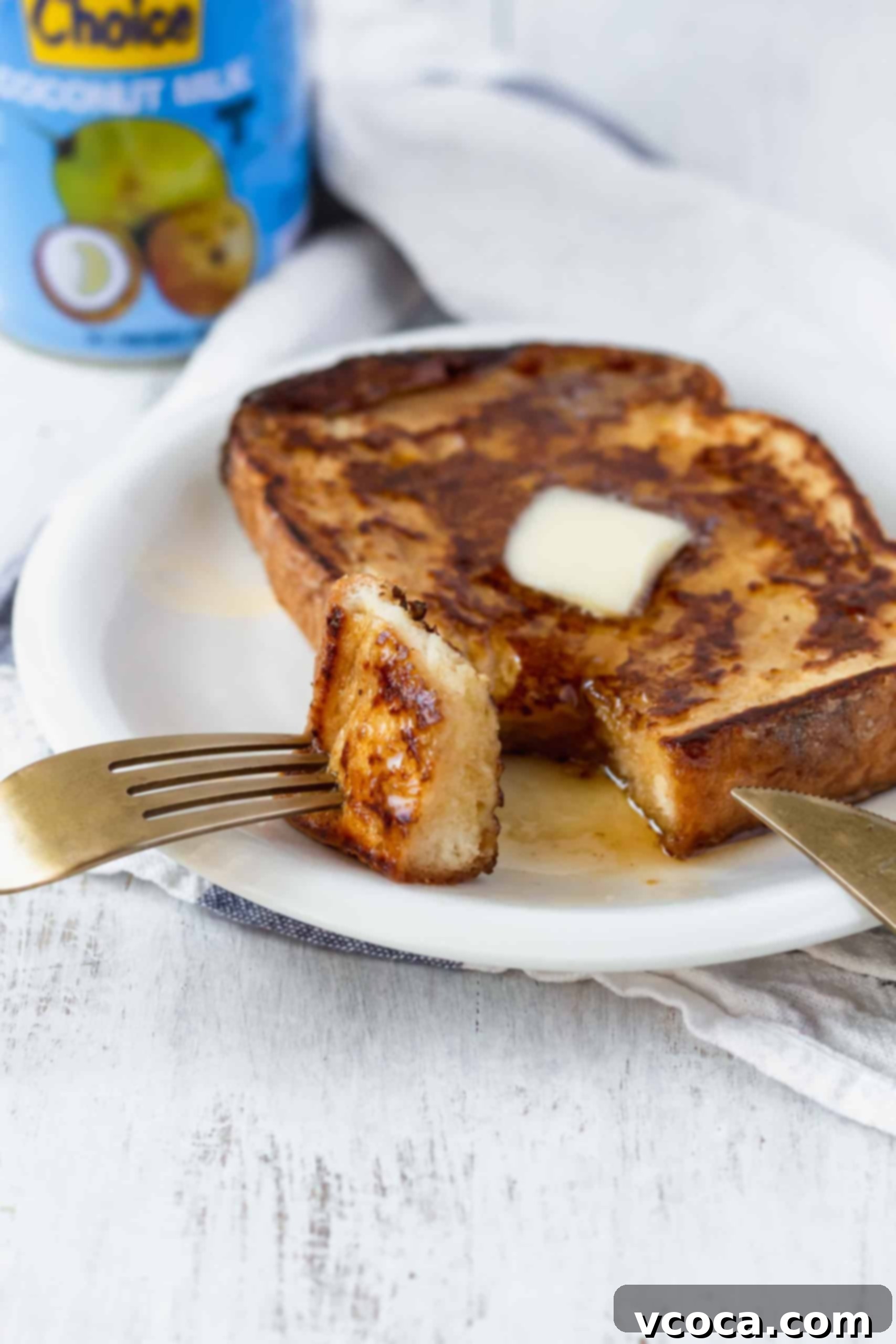 Effortlessly Delicious Vegan French Toast 6 Two plates of delicious vegan French toast, one topped with fresh blueberries and powdered sugar, the other with sliced bananas and a drizzle of maple syrup. Both are perfect for a vibrant plant-based breakfast or brunch.