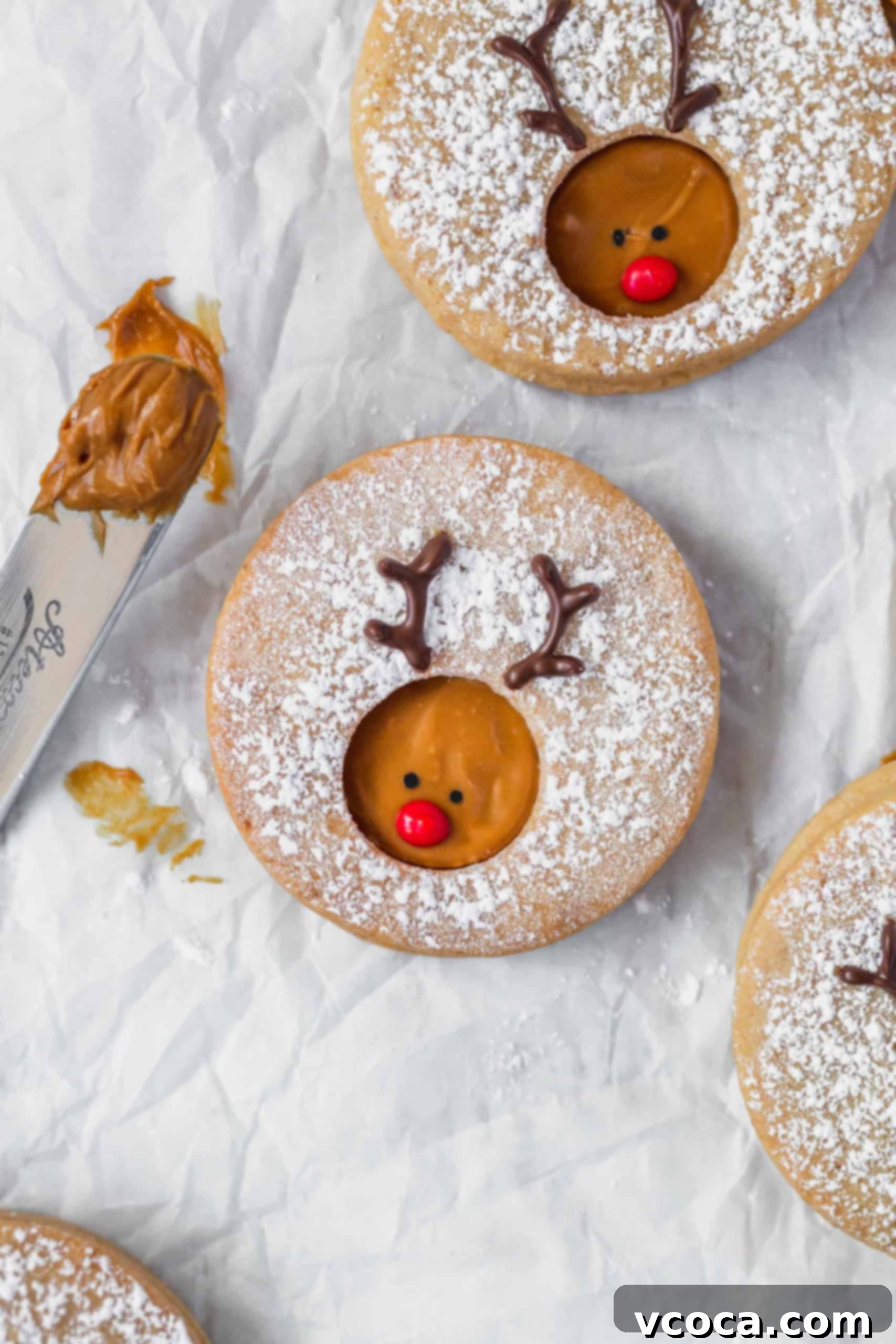 Rudolph's Holiday Reindeer Cookies 2 Rudolph reindeer cookies on a white surface.