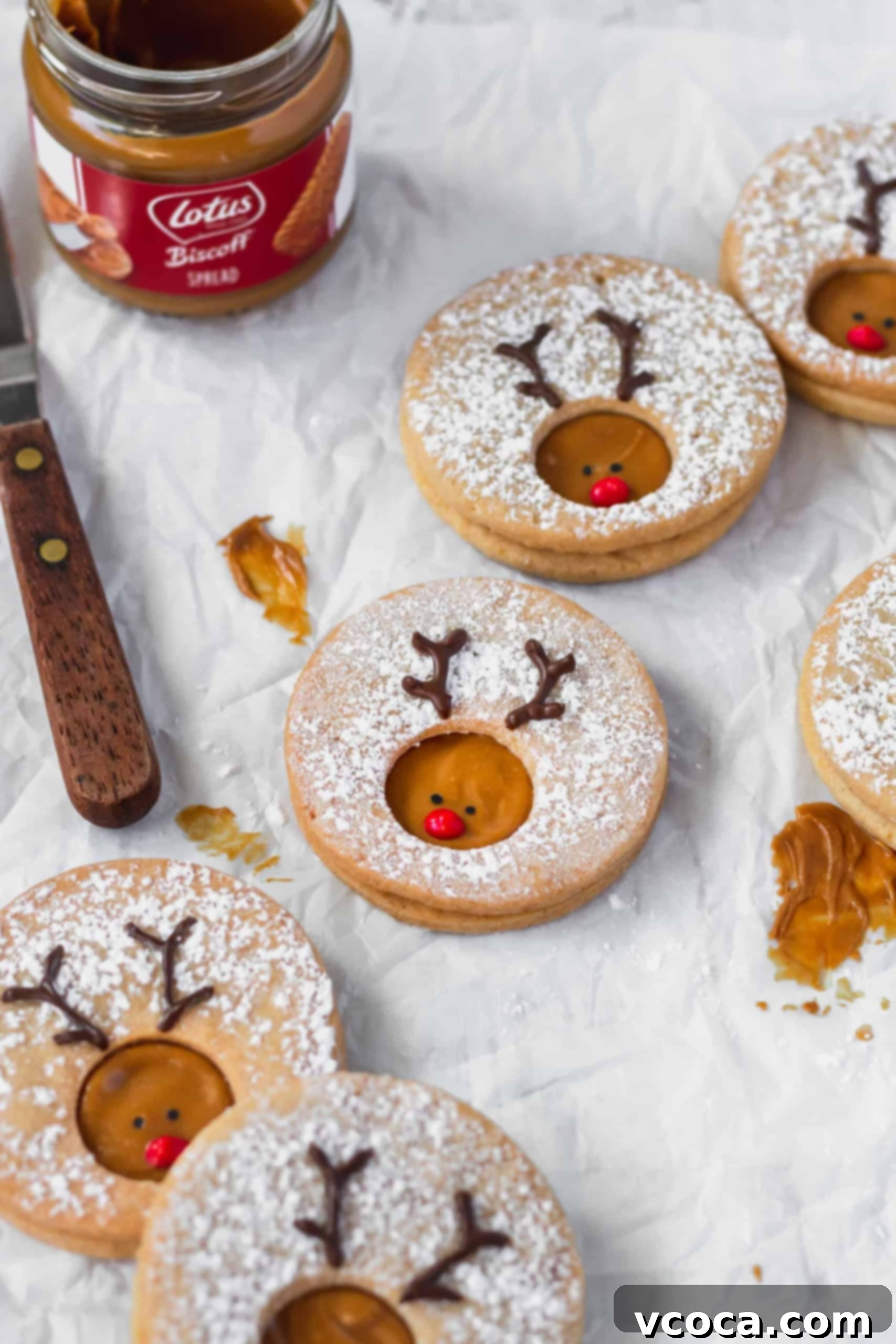 Rudolph's Holiday Reindeer Cookies 4 Rudolph cookies scattered on a piece of parchment paper.