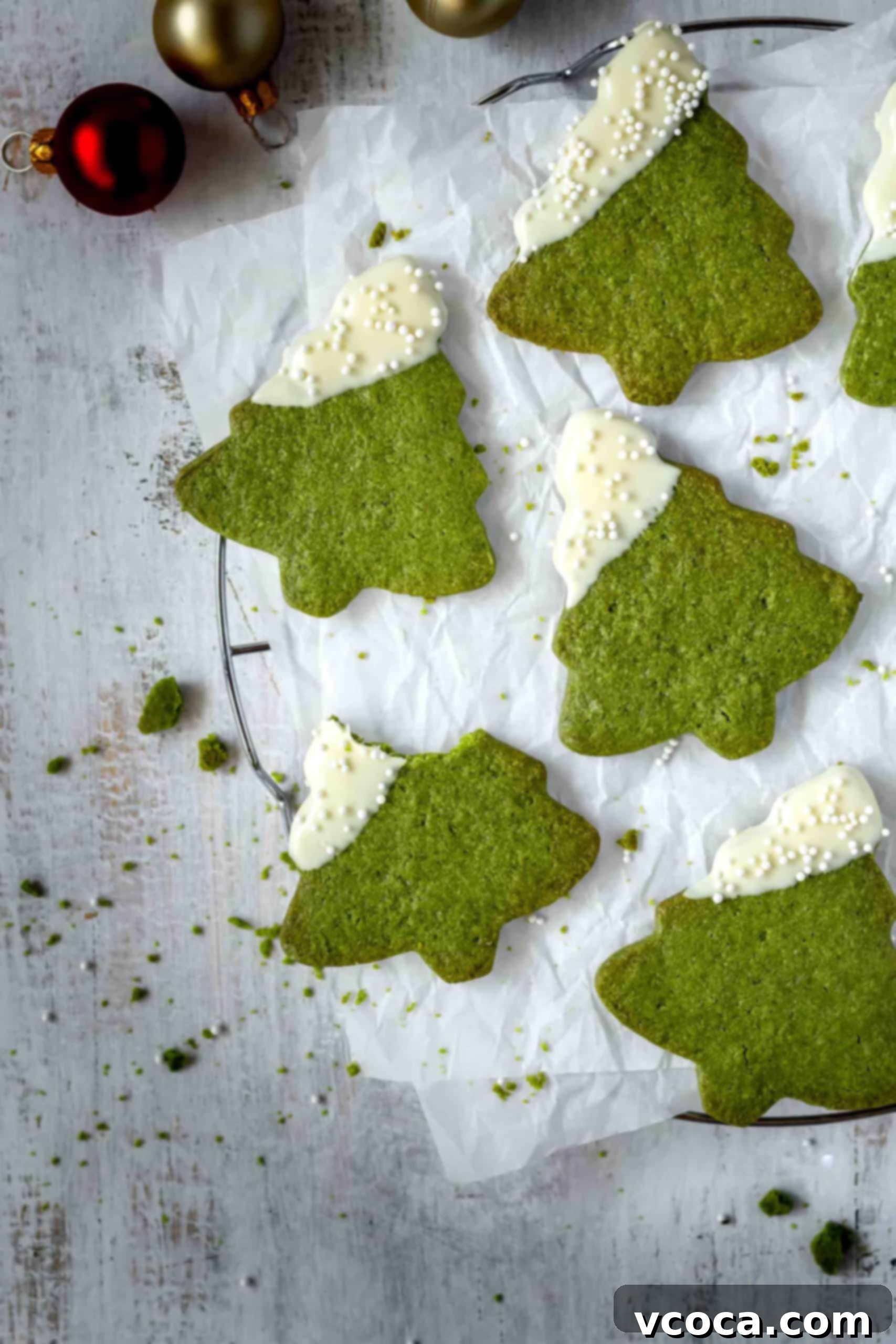 Festive Matcha Christmas Tree Cookies 7 Stack of exquisitely decorated Matcha Christmas Tree Cookies, featuring a pristine white chocolate dip and a scattering of festive nonpareil sprinkles, perfect for holiday gifting or serving.