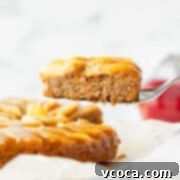 Pure Plant Apple Cake Bliss 6 A slice of vegan apple cake being lifted up, showing the beautiful apple and caramel layer.