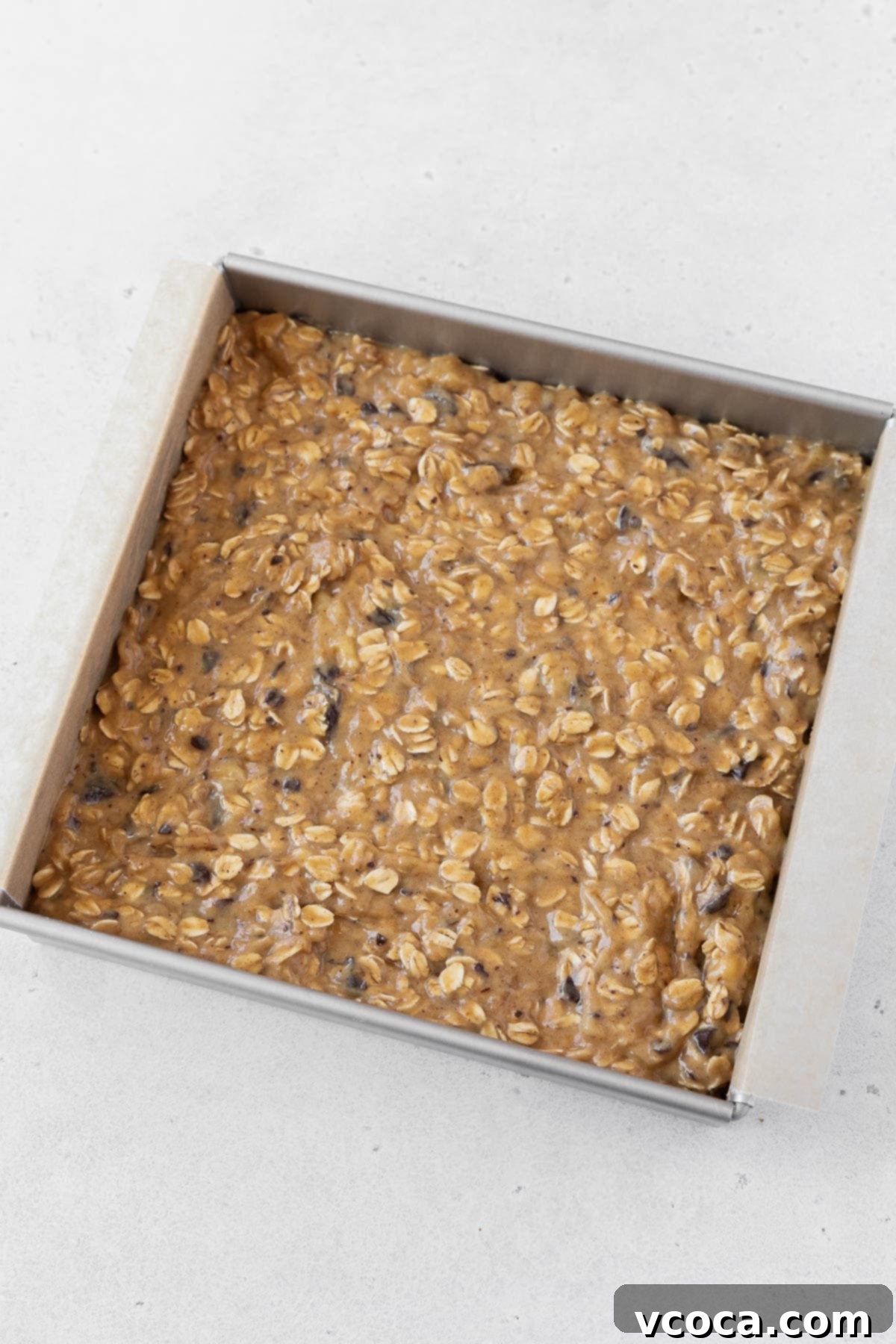 Gluten Free Peanut Butter Oatmeal Breakfast Bars 11 A pan of peanut butter banana oatmeal bars before going into the oven.