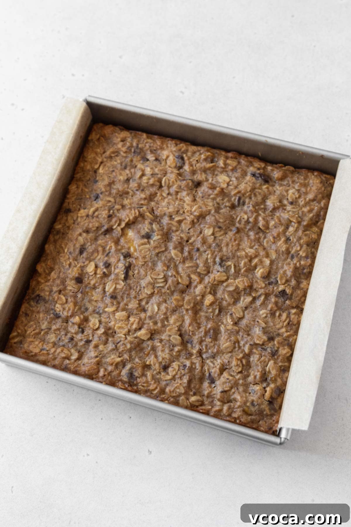 Gluten Free Peanut Butter Oatmeal Breakfast Bars 12 A baked pan of peanut butter banana oatmeal bars on the counter.
