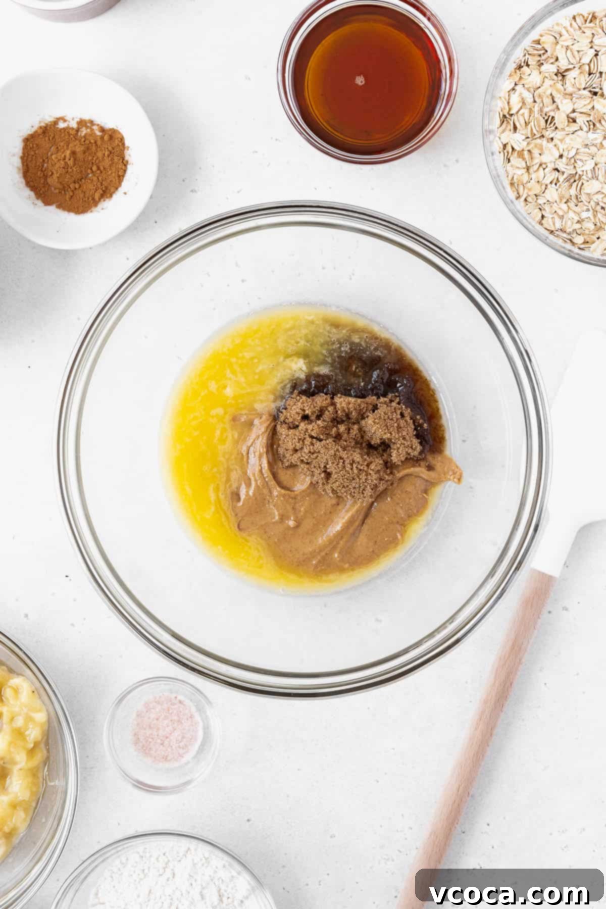 Gluten Free Peanut Butter Oatmeal Breakfast Bars 5 A mixing bowl with melted vegan butter, brown sugar, peanut butter, and maple syrup.