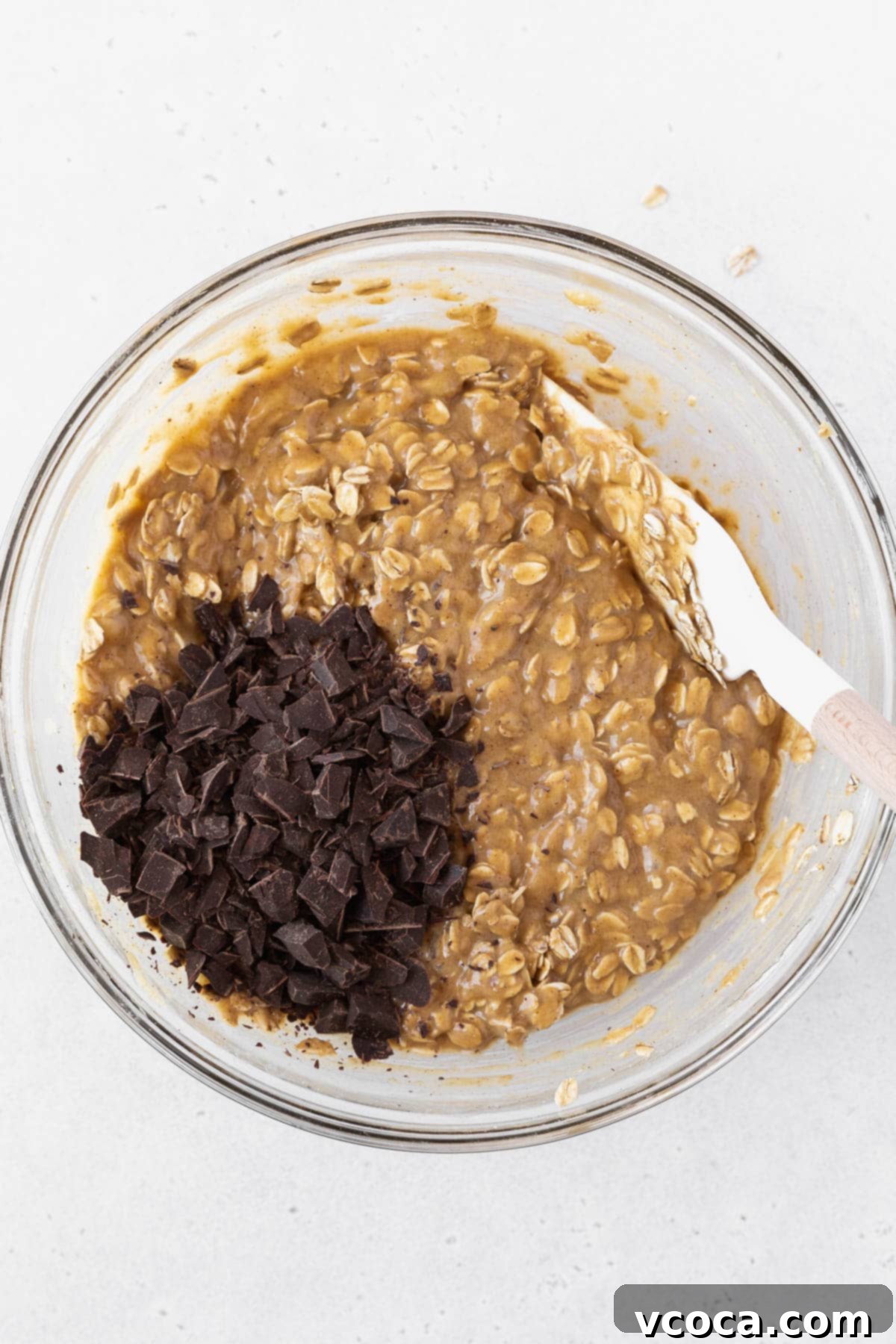Gluten Free Peanut Butter Oatmeal Breakfast Bars 10 Stirring the shaved chocolate into the peanut butter banana oatmeal bar batter.