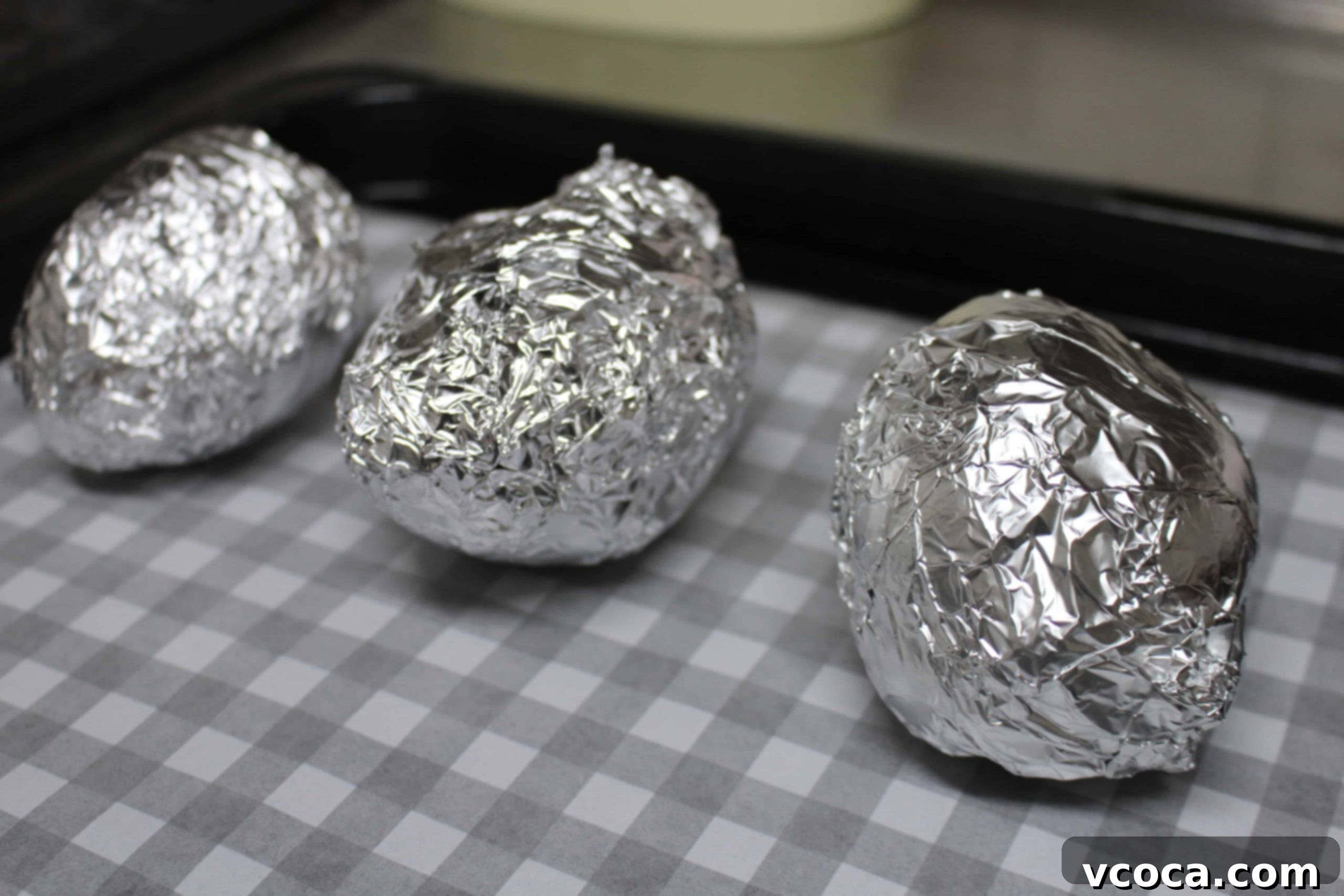 Caramelized Japanese Sweet Potatoes 4 Japanese sweet potatoes individually wrapped in aluminum foil, ready for baking.