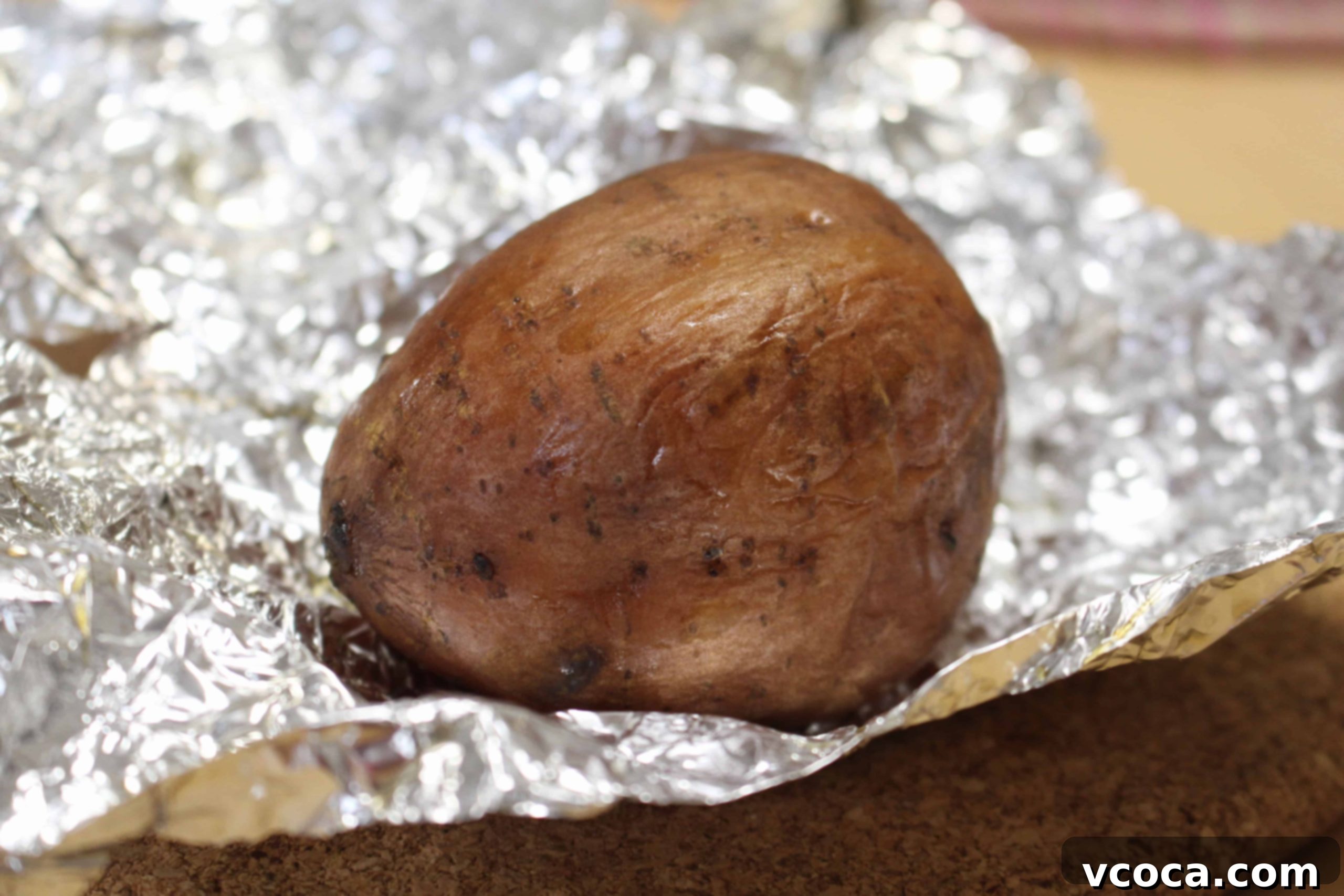 Caramelized Japanese Sweet Potatoes 6 A perfectly baked Japanese sweet potato, removed from foil, showing its soft, moist interior.