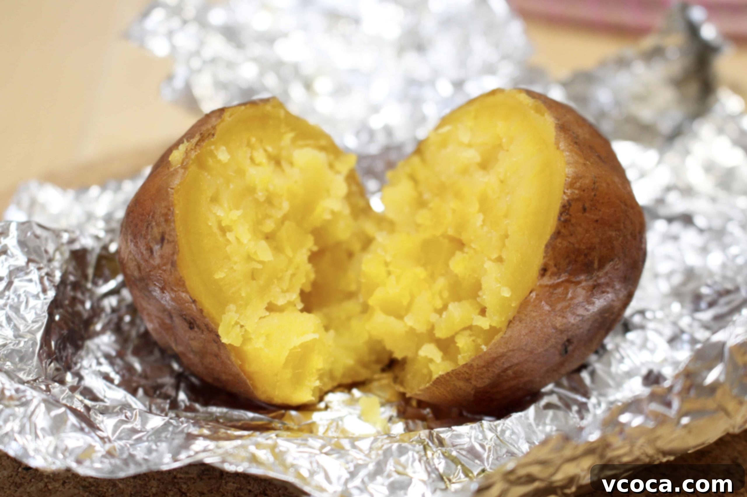 Caramelized Japanese Sweet Potatoes 7 A close-up of a baked Japanese sweet potato, split open to reveal its moist, golden flesh.