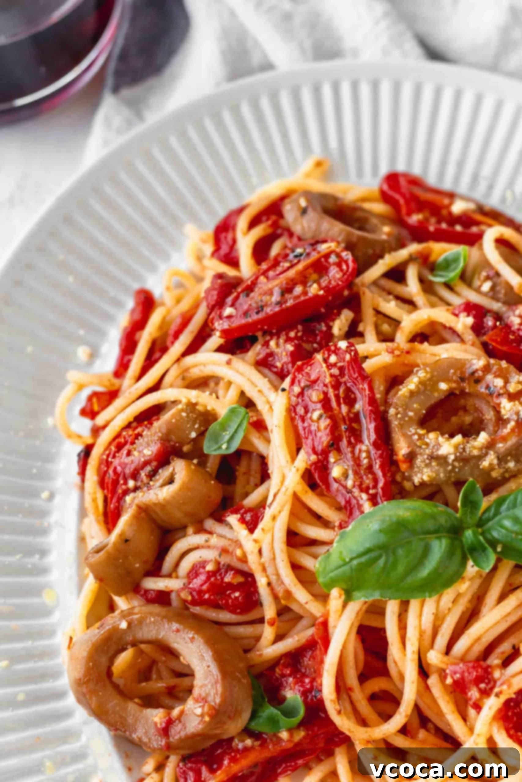 Sun-Drenched Tomato Pasta with Crispy Vegan Calamari 7 Close up of gluten-free spaghetti tossed with vibrant roasted cherry tomatoes and savory vegan calamari.