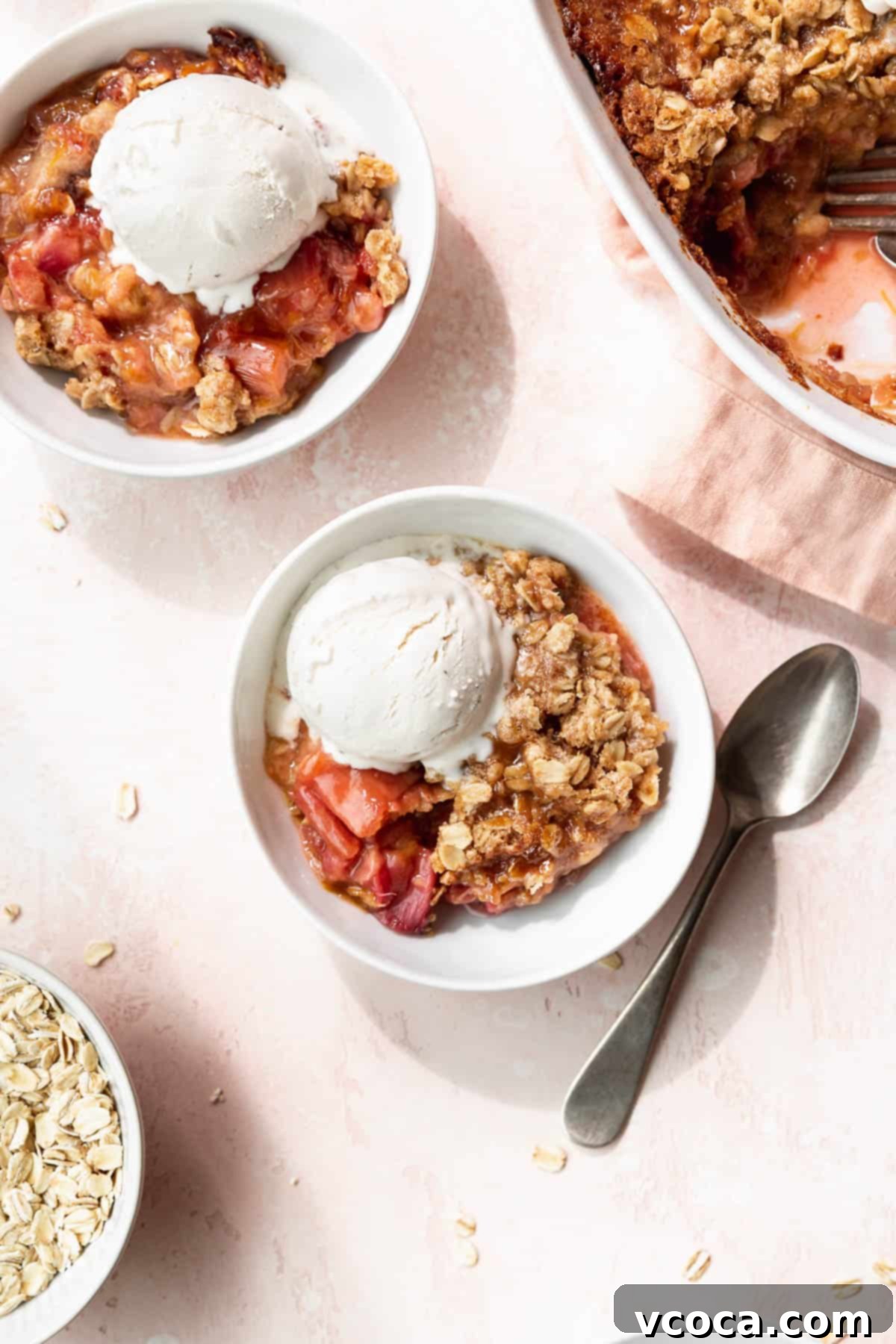 Sweet & Tart Gluten-Free Rhubarb Crisp 3 Overhead shot of two bowls of vegan rhubarb crisp topped with vanilla ice cream.