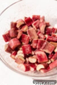 Closeup shot of chopped rhubarb after mixing with sugar and cornstarch.