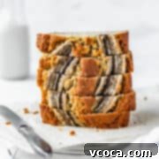 A stack of moist banana bread with a white background.
