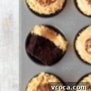 Decadent Chocolate Peanut Butter Cupcakes 5 A chocolate cupcake in a muffin tin with peanut butter frosting.