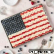 Festive 4th of July Fruit Pizza 15 A square image of the entire sheet pan of gluten-free and dairy-free American flag dessert pizza with blueberries, bananas, and strawberries.
