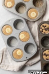 Banana muffin batter in a muffin pan.
