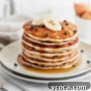 Fluffy Gluten-Free Banana Pancakes 6 A stack of golden-brown gluten-free banana pancakes, beautifully drizzled with rich maple syrup. The image highlights the fluffy texture and inviting aroma of this delicious breakfast treat.