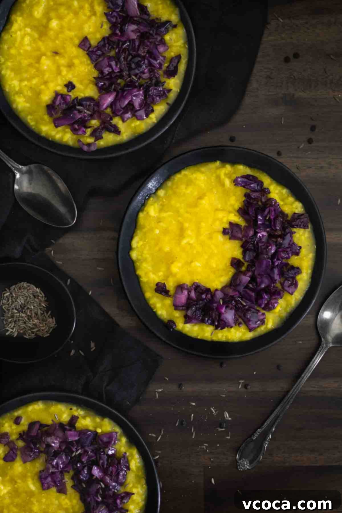 Hearty Cabbage and Onion Khichdi 2 A comforting bowl of Khichdi, an Indian rice and lentil porridge, topped with vibrant red cabbage and caramelized onions, ready to be enjoyed.