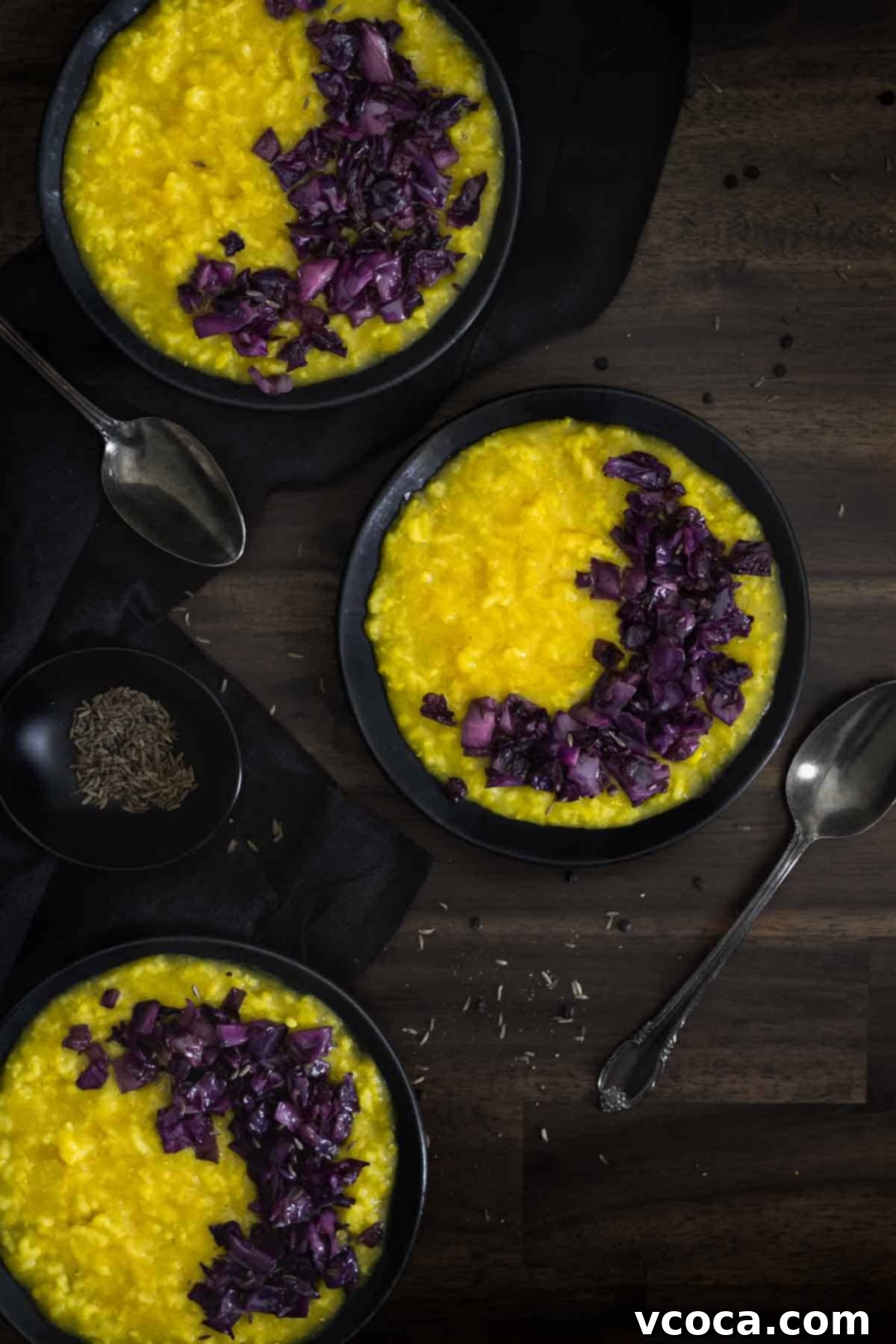 Hearty Cabbage and Onion Khichdi 3 Three beautifully presented plates of Khichdi, a wholesome Indian rice and lentil porridge, showcasing the creamy texture and inviting yellow hue.
