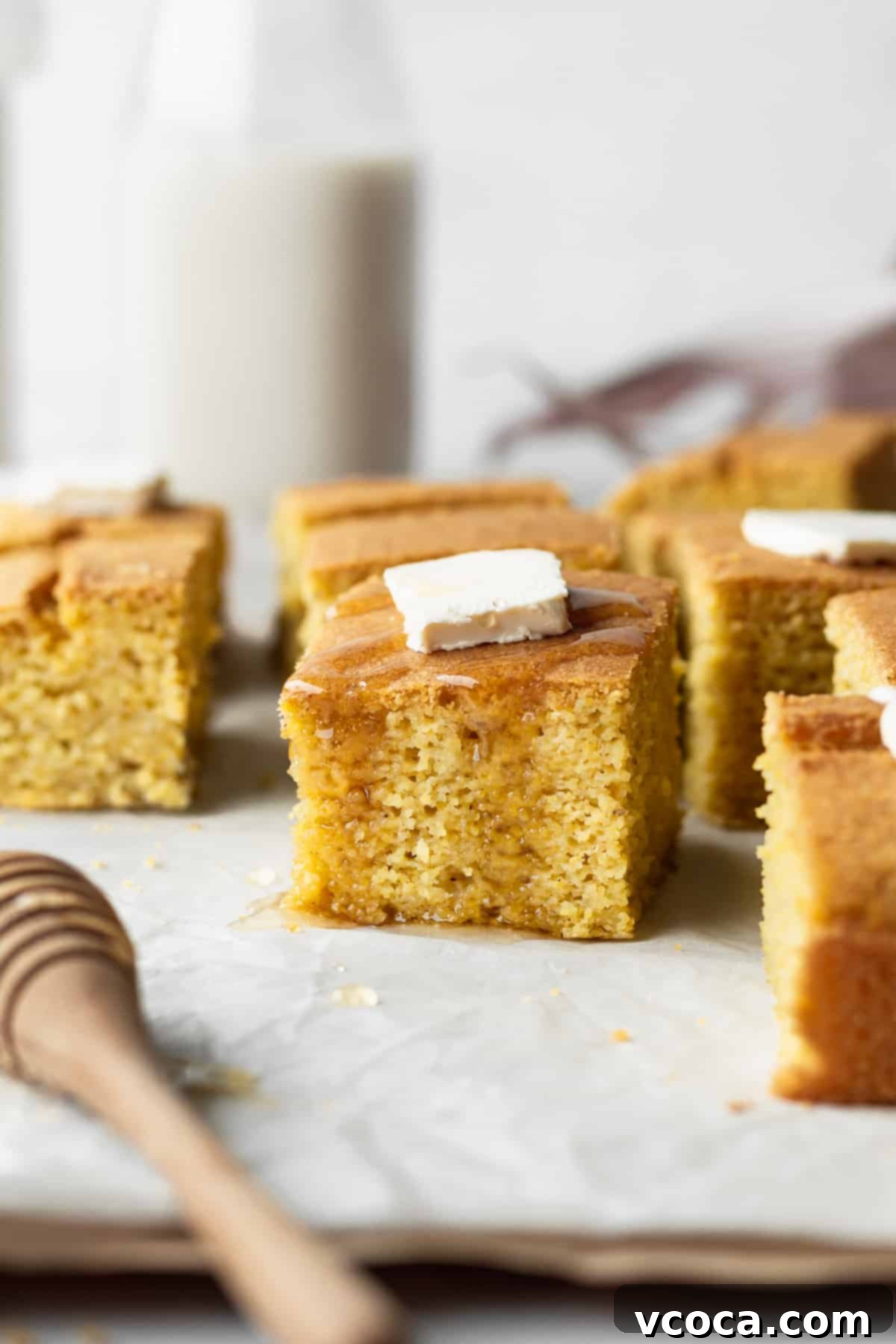 Golden Gluten Free Cornbread 2 A square piece of moist and fluffy gluten-free cornbread with a pad of butter and drizzle of honey. This sweet and savory cornbread is made with fresh corn for deep flavor, perfect for any meal.