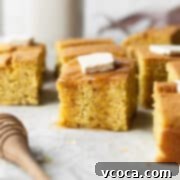 Golden Gluten Free Cornbread 13 A square piece of gluten-free cornbread with a pad of butter and drizzle of honey. This moist, fluffy, sweet and savory cornbread is a perfect side dish or snack.