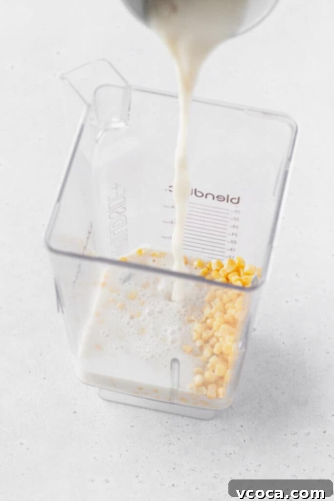 Golden Gluten Free Cornbread 6 Non-dairy buttermilk added to corn in the blender, preparing for a smooth and flavorful gluten-free cornbread batter.
