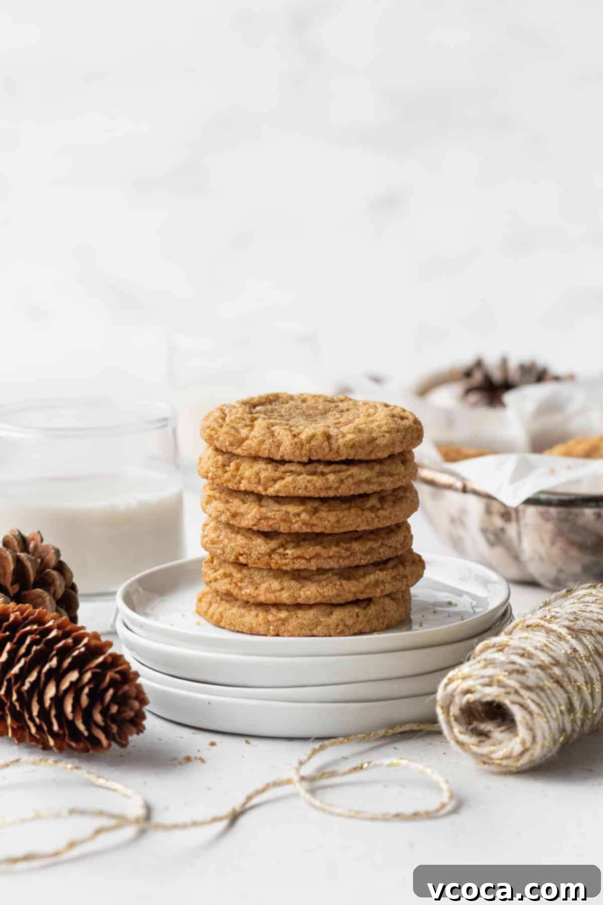 Heavenly Chewy Gluten-Free Ginger Cookies 3 A stack of golden-brown ginger cookies resting on pristine white plates, ready to be enjoyed.