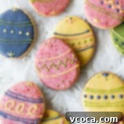Joyful Easter Cookie Delights 14 Square hero shot of decorated Easter egg sugar cookies, showcasing their colorful natural icing.
