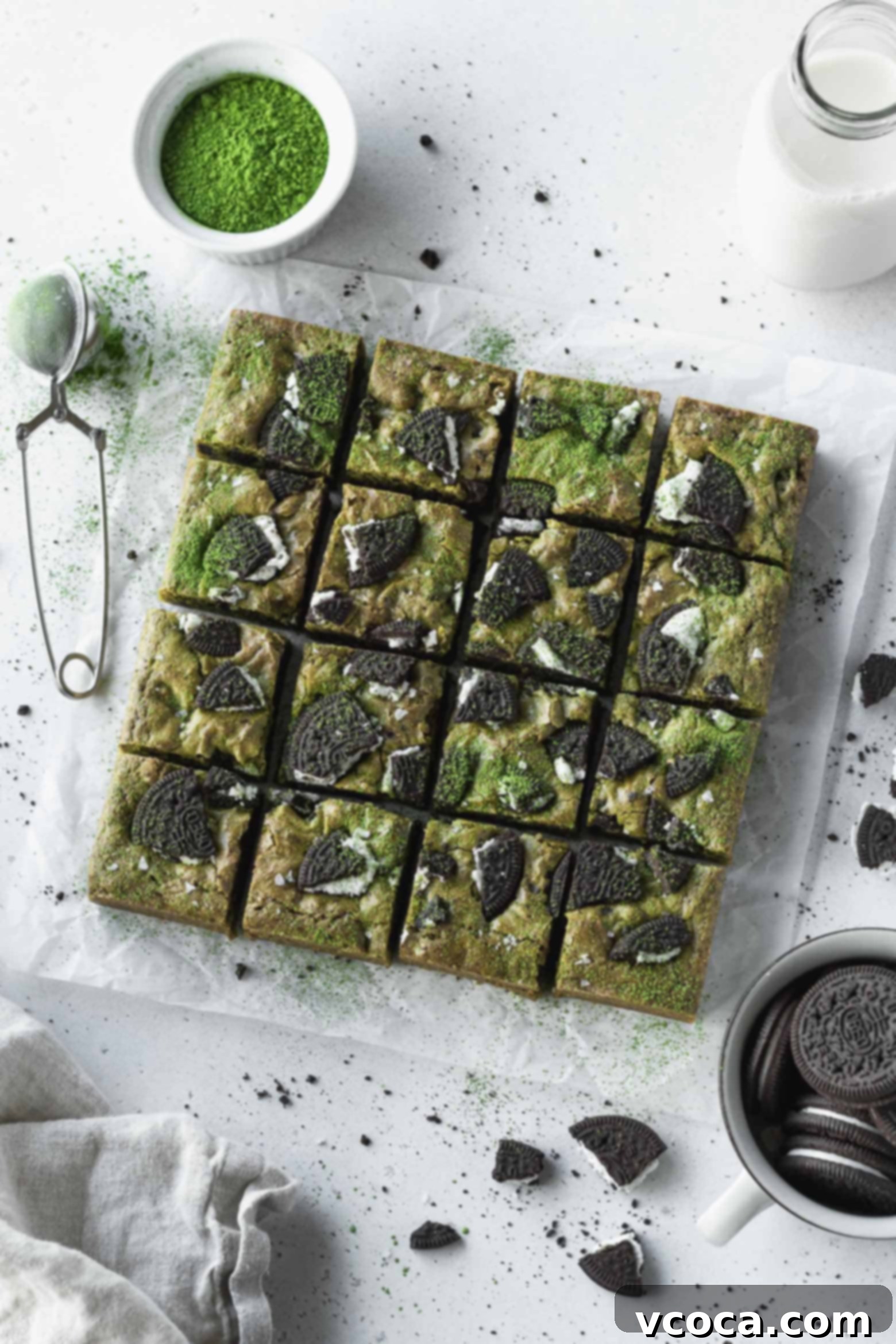 Delectable Matcha Oreo Blondies 2 Matcha oreo blondies cut into squares, showcasing their vibrant green color and cookie pieces