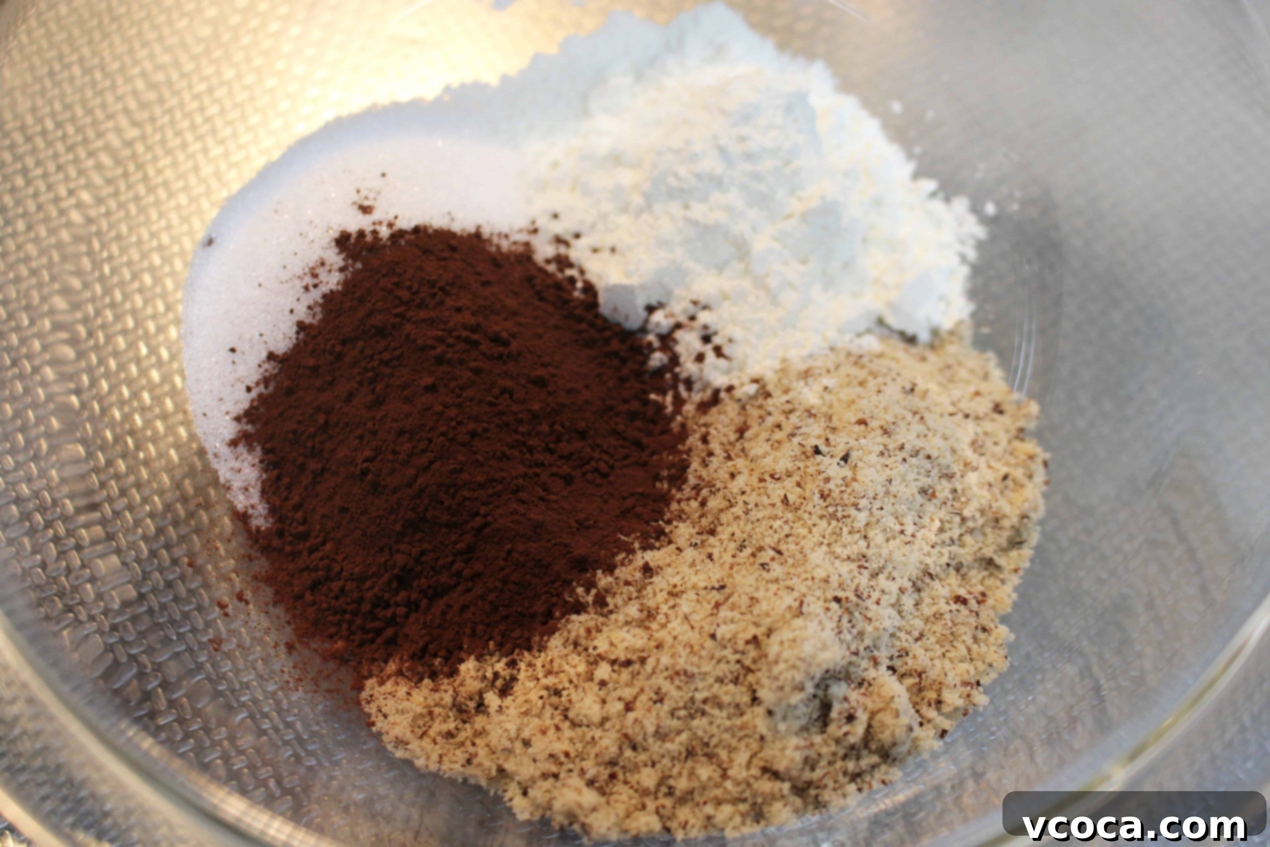Decadent Chocolate Hazelnut Financiers 3 The smooth, rich batter for chocolate hazelnut financiers in a mixing bowl.