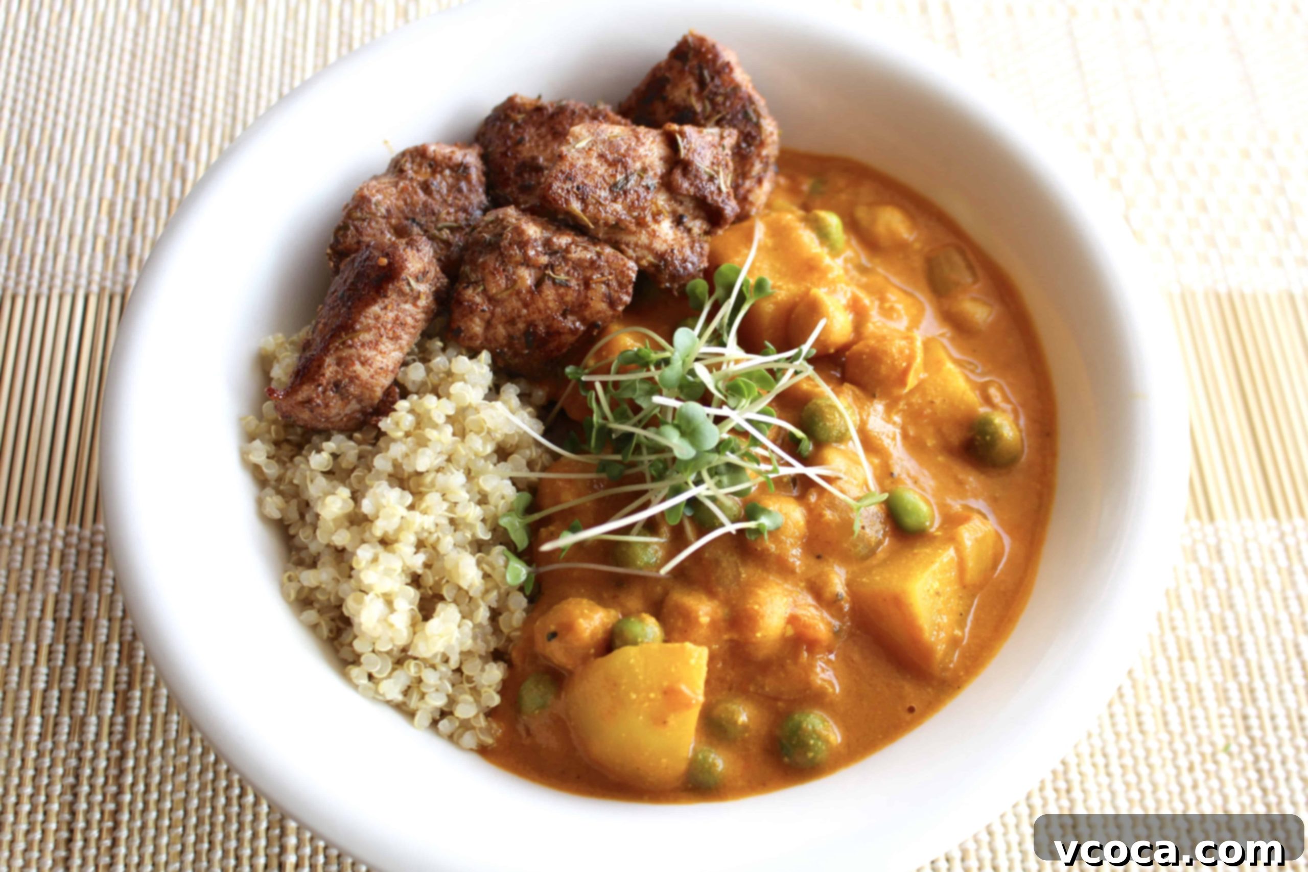 Spicy Jerk Chicken and Hearty Chickpea Curry 8 A perfectly plated Rasta Veggie Bowl replica featuring creamy chickpea curry, golden jerk chicken, and a side of quinoa.