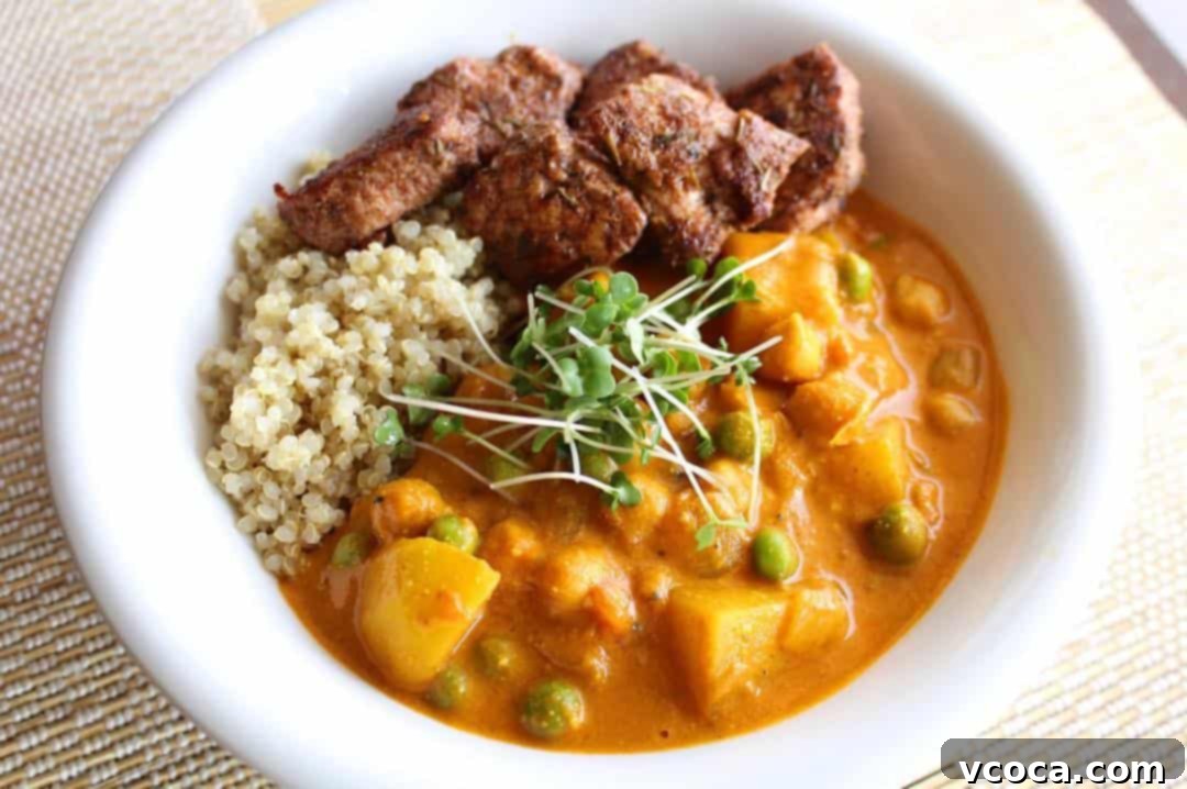 Spicy Jerk Chicken and Hearty Chickpea Curry 9 A bowl of creamy chickpea curry topped with golden jerk chicken pieces, ready to be served.