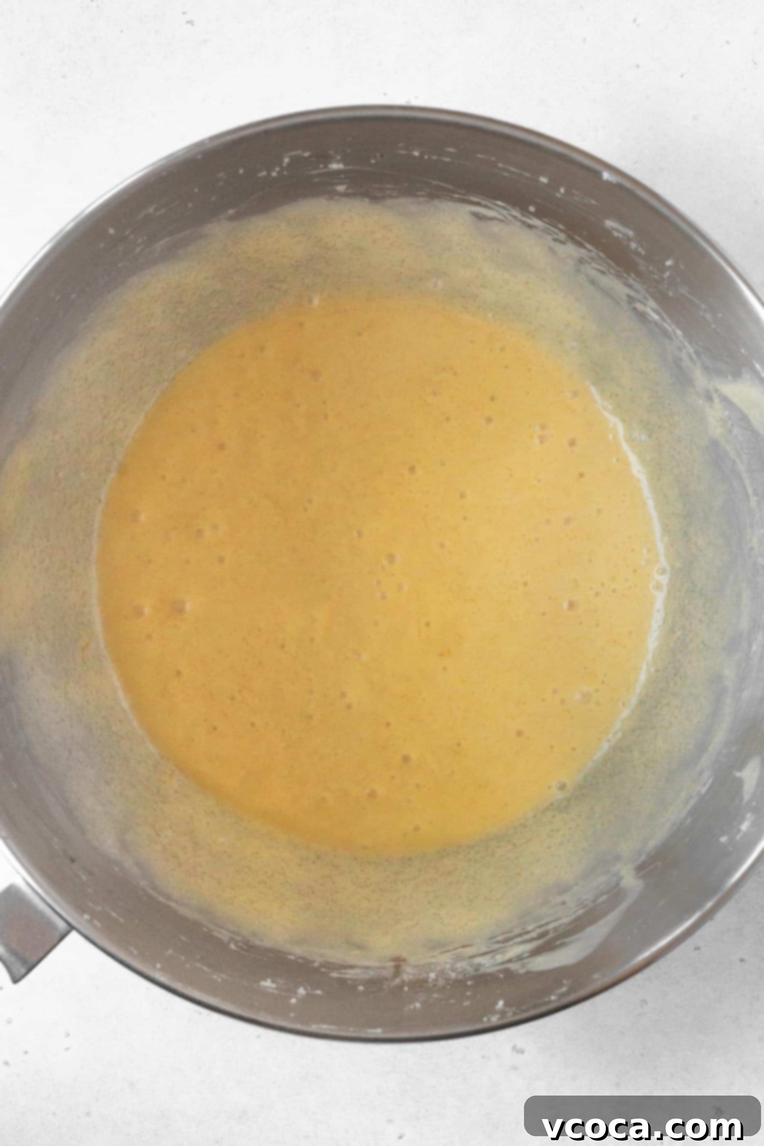 Indulgent Gluten-Free Pound Cake 9 Smooth pound cake batter in a stand mixer bowl, indicating proper mixing.