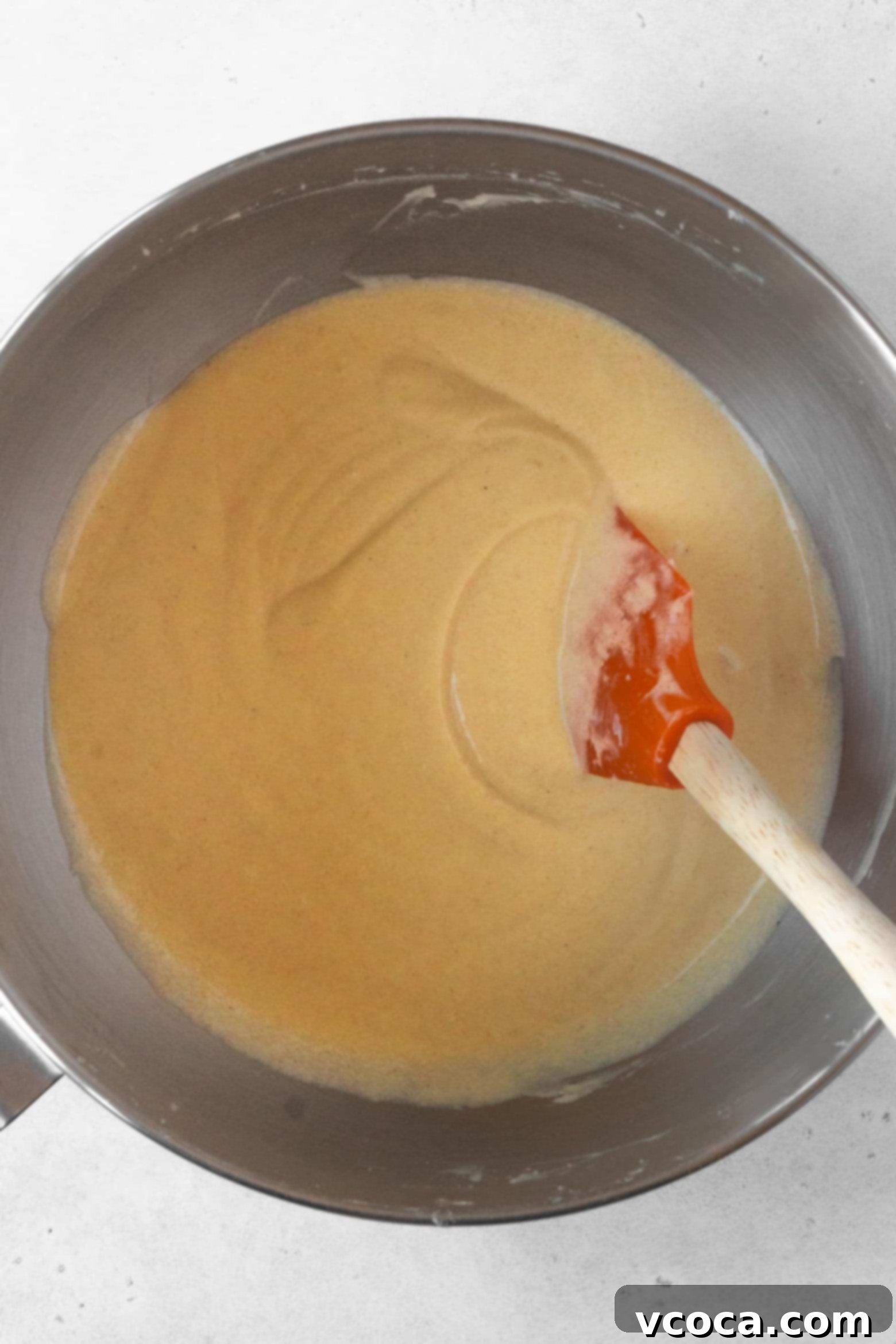Indulgent Gluten-Free Pound Cake 10 Scraping down the sides of the bowl to ensure a homogenous pound cake batter.