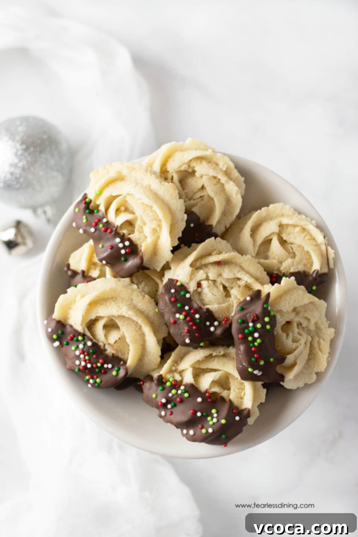 Irresistible Gluten-Free Christmas Treats 7 A plate of Danish butter cookies dipped in chocolate with some Christmas sprinkles.