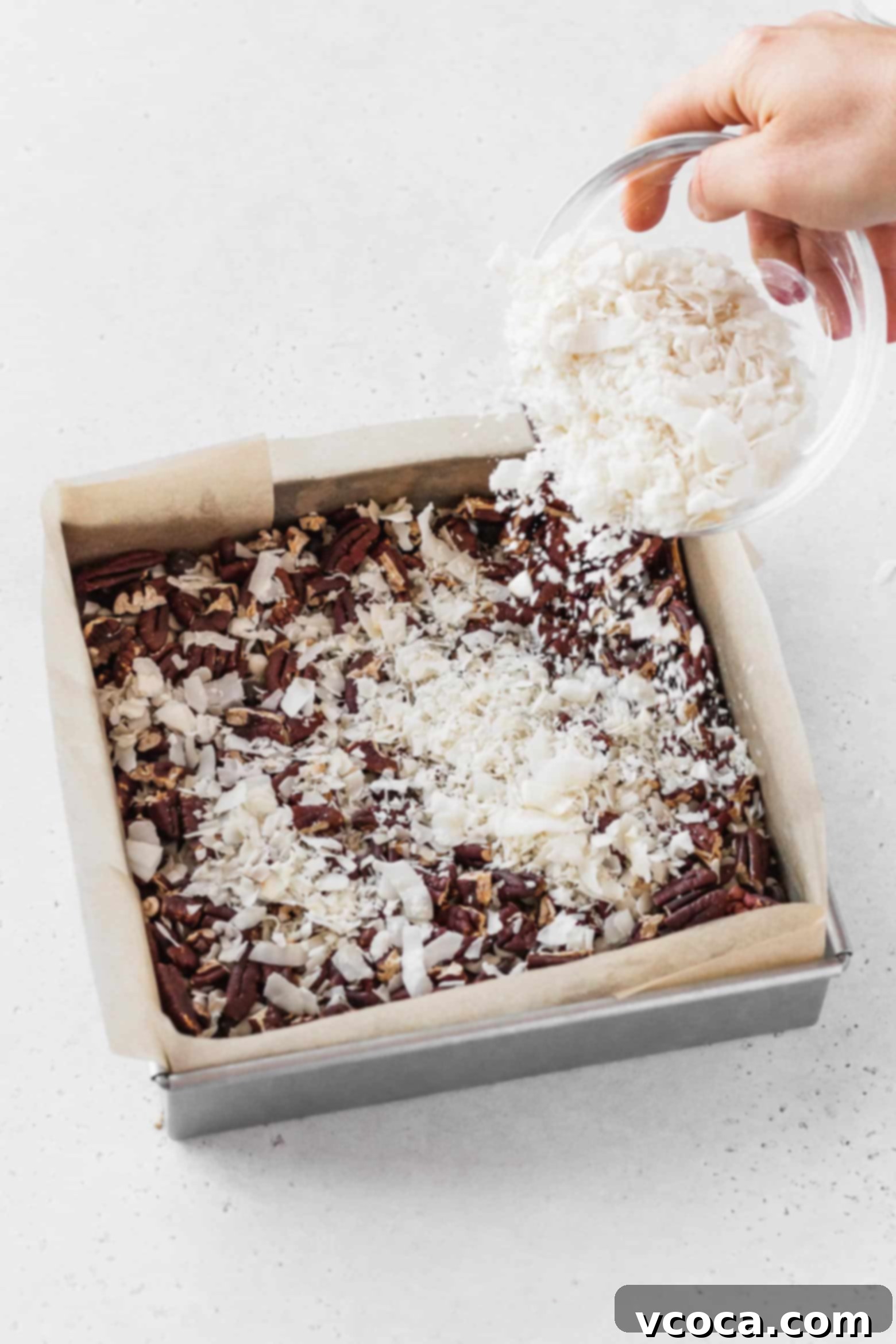 Magical Vegan Seven Layer Bars 12 Sprinkling flaked coconut over the chopped pecans.