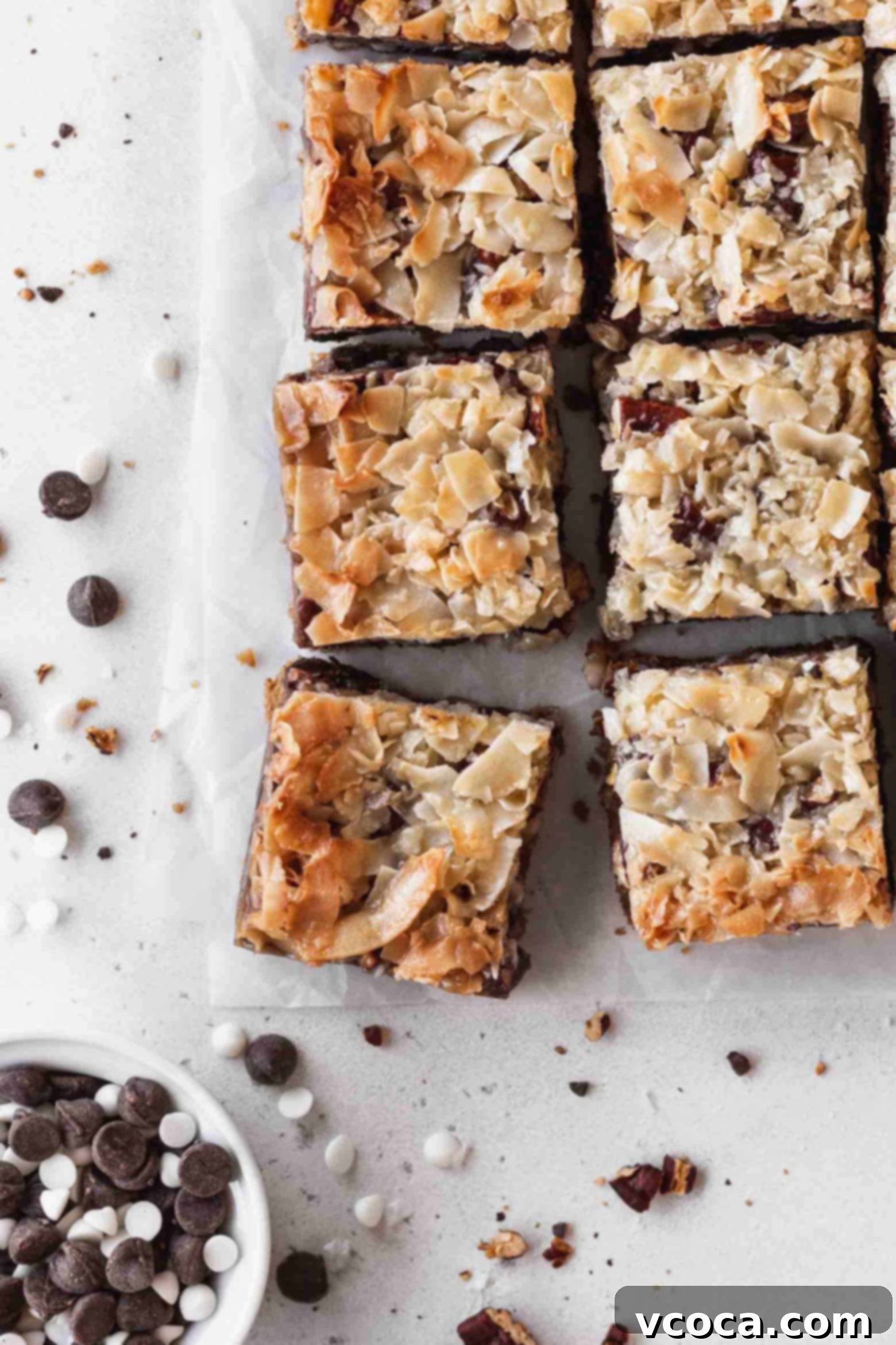 Magical Vegan Seven Layer Bars 18 7 layer magic bars with a dish of chocolate chips.