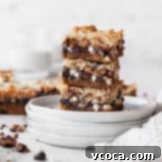 Magical Vegan Seven Layer Bars 19 A stack of vegan magic bars on white plates.