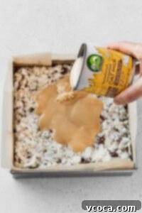 Pour a can of vegan sweetened condensed milk over the coconut.