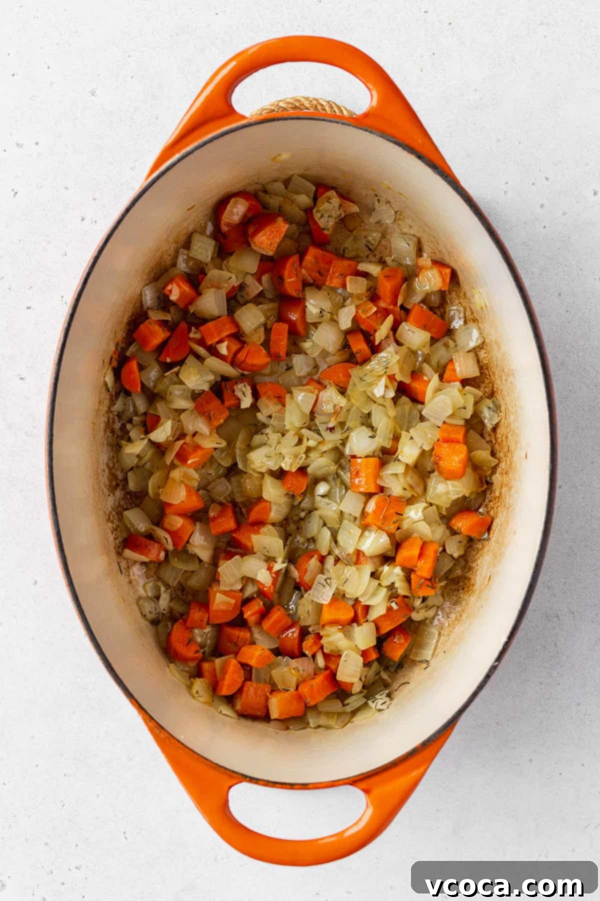 Vegan Chicken Pot Pie 7 Sautéed chopped onions, celery, carrots, and minced garlic in an enameled Dutch oven, glistening with olive oil.